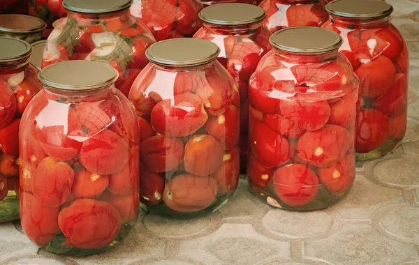 Tinned tomatoes in big glass jars. — Stock Photo, Image