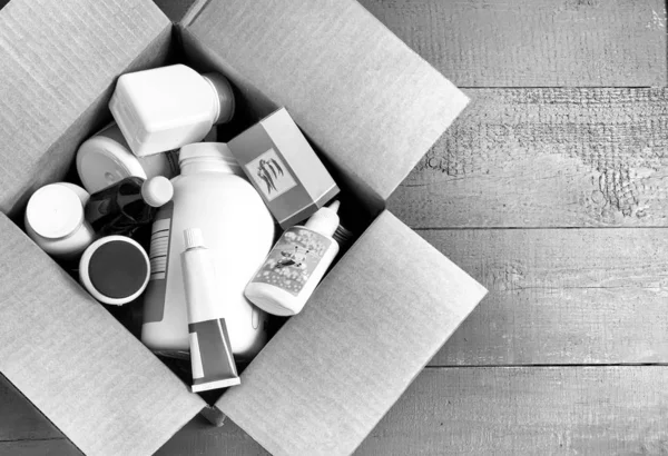 Médicaments et cosmétiques dans une boîte en carton, image en noir et blanc — Photo