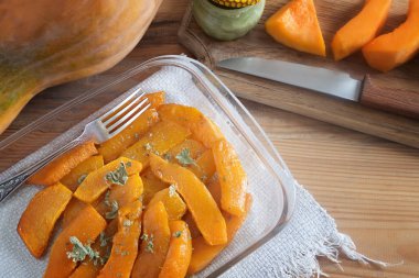 Balkabağı dilimleri, bal ve bitkilerle pişirilmiş.