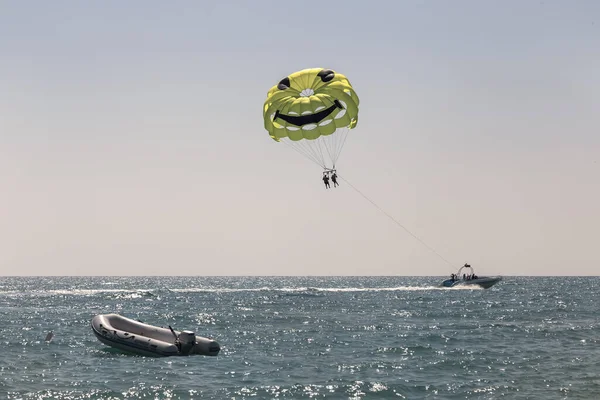 Extreme entertainment parasailing: parachuting over the sea after a boat using a cable
