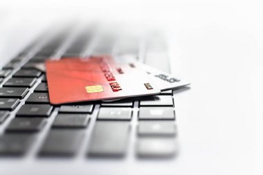 Bir kredi kartının yakın çekimi dizüstü bilgisayarın klavyesinde yatıyor. Çevrimiçi alışveriş kavramı, çevrimiçi ödeme süreci, hackerların mali işlemlerinin güvenliği, e-ticaret, banka kredisi.