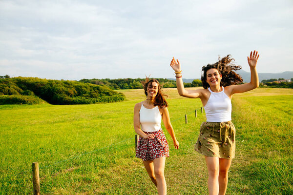 Funny friends jumping in nature