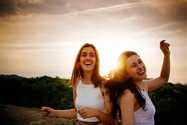 Women dancing at sunset outdoors — Stock Photo, Image