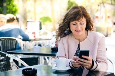 Cep telefonu kullaranarak orta yaşlı kadın