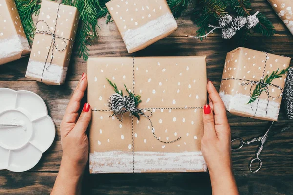 Woman wrapping Christmas presents in a crafty way — Stock Photo, Image