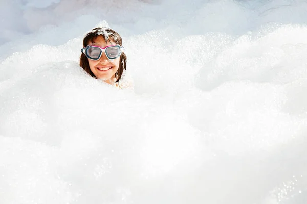Little girl having fun at the foam party — Stock Photo, Image