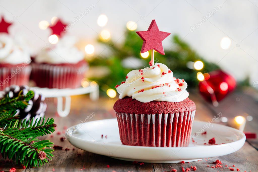 Christmas red velvet cupcakes with Christmas lights and ornament