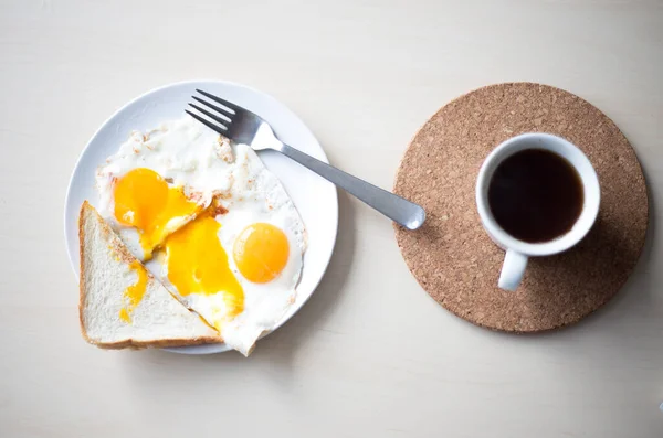 아침 식사로 빵 과 블랙 커피를 구운 오렌지 노른자 두 개. — 스톡 사진