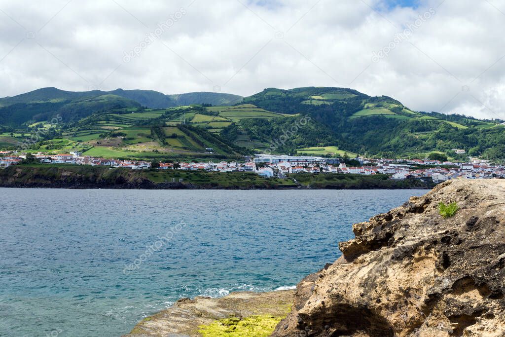 View of the beautiful village of Vila Franca do Campo on the island of San Miguel from the volcanic uninhabited island of Vila Franca, Azores, Portugal. Travel to the Azores.