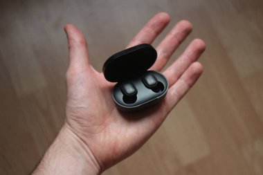 Avuçta siyah bluetooth kulaklıklar
