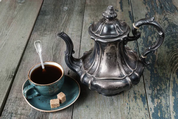 Antique coffee pot and cup of coffee — Stock Photo, Image