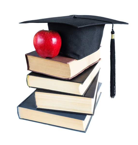Yüksek lisans şapka, kitaplar ve elma — Stok fotoğraf