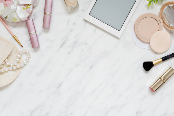 Woman's workplace with cosmetic and smartphone 