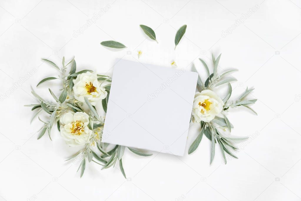 Decorative composition with paper card and rose flowers