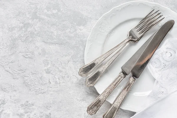 Silverware on a porcelain plates — Stock Photo, Image