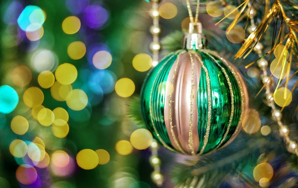 Green Christmas ball is on a Christmas tree