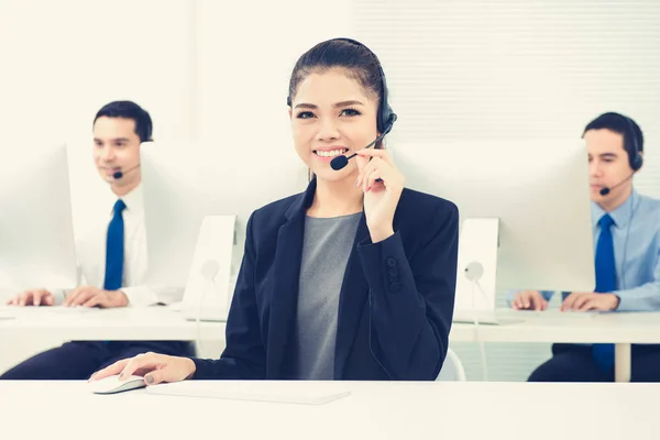 Young Asian woman as an operator working in call center — Stock Photo, Image