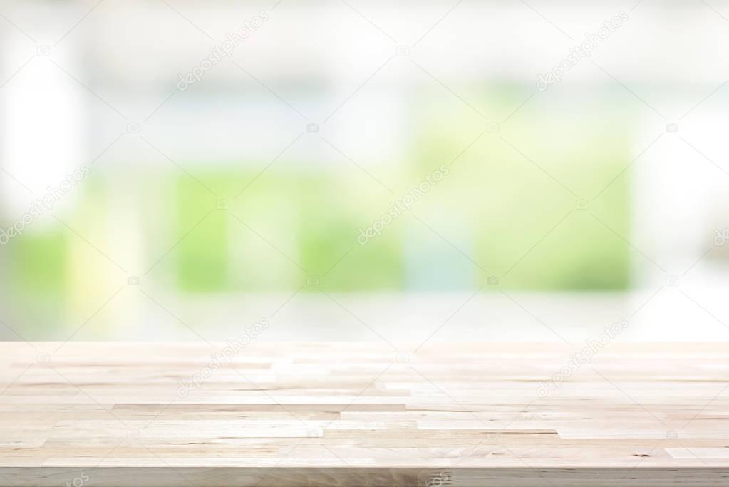 Wood table top on blur white green kitchen window background