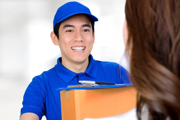 Smiling delivery man delivering a package
