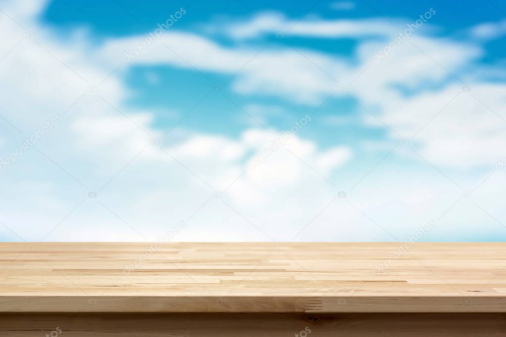 Wood table top on blur summer blue sky and cloud background