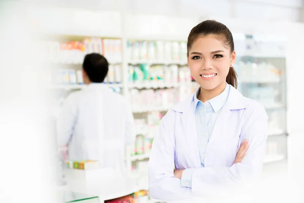 Lachende Aziatische vrouw apotheker in apotheek — Stockfoto