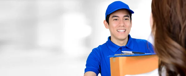 Sorrindo entregador entregando um pacote — Fotografia de Stock