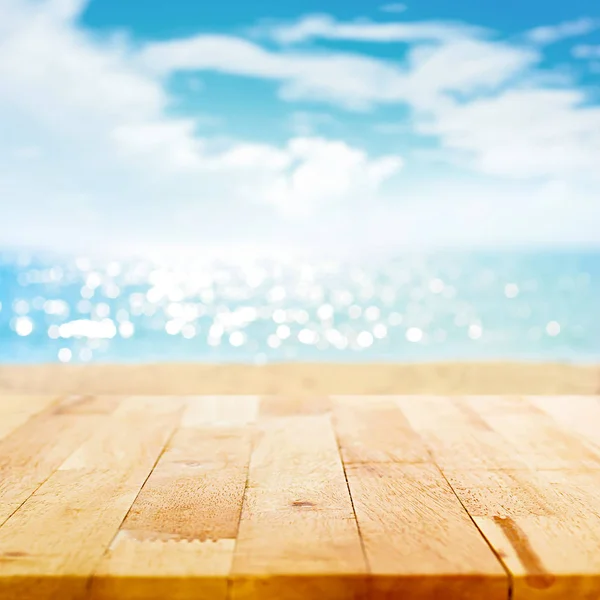 Houten tafelblad op zomer strand achtergrond wazig — Stockfoto