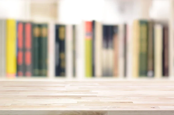 Wood table top on blur bookshelf background