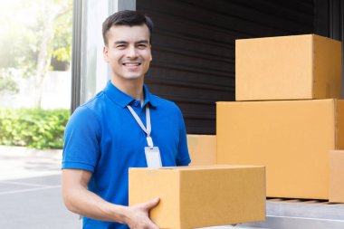 A man carrying  package from delivery car  clipart