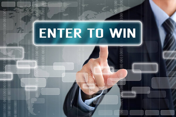 Businessman hand touching ENTER TO WIN message on virtual screen