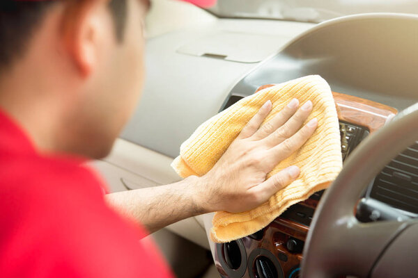 A man cleaning car interior