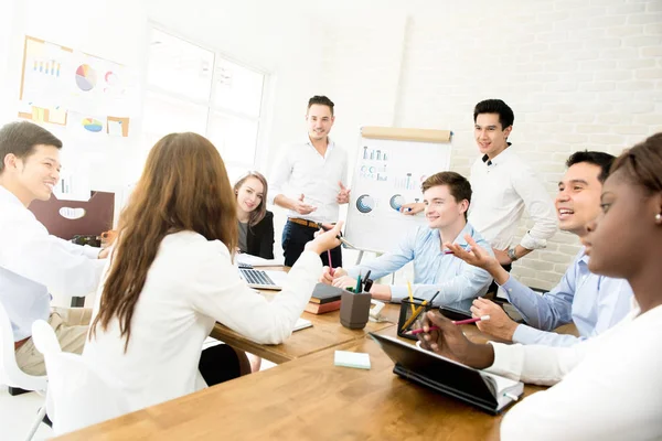 Young interracial business team discussing work at the meeting — Stock Photo, Image