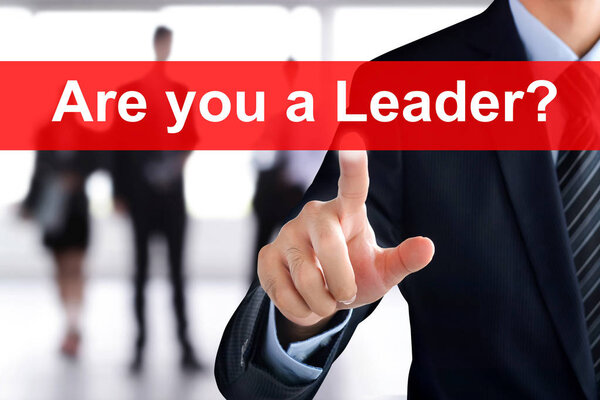 Businessman hand touching ARE YOU A LEADER? message on virtual screen