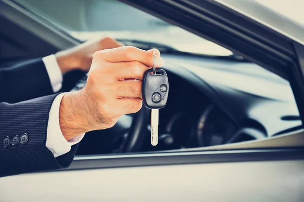 Businessman hand holding a car key — Stock Photo, Image