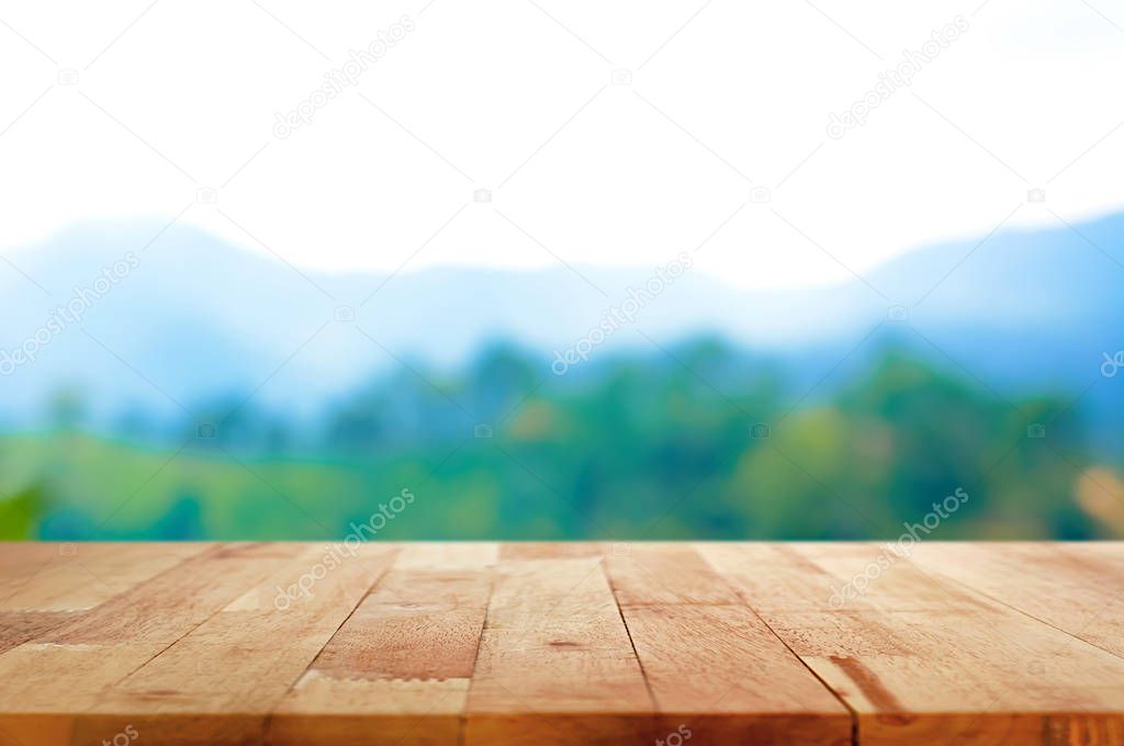 Wood table top on blur mountain background