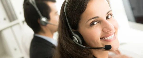 Smiling customer service staff in call center — Stock Photo, Image