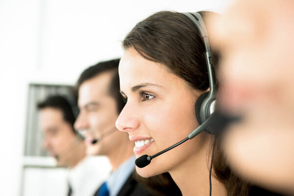 Smiling customer service team in call center