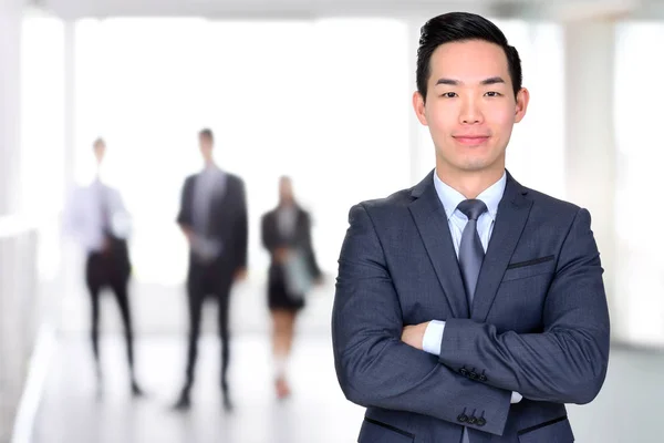 Sonriente asiático hombre de negocios cruzando sus brazos — Foto de Stock