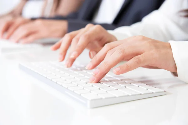 Hands typing on computer keyboards — Stock Photo, Image