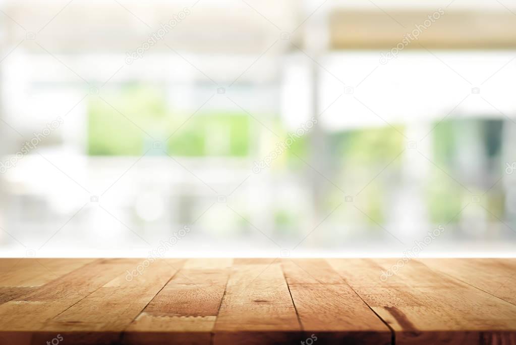 Wood table top on blur kitchen window background 