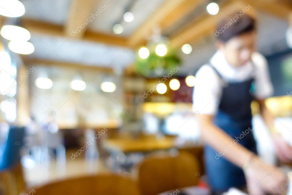 Blur coffee shop (or restaurant) interior with a staff
