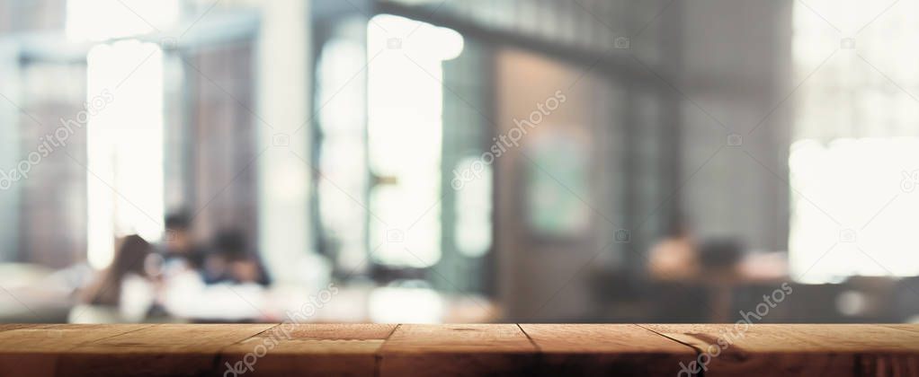 Wood table top on blur restaurant (cafe) interior background 