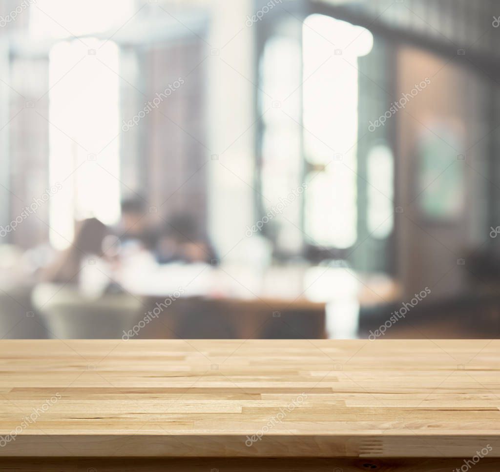 Wood table top on blur restaurant (cafe) interior background 