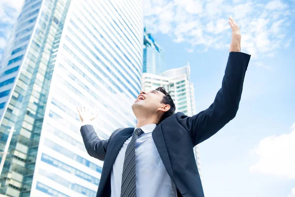 Businessman raising his arms opening palms with face looking up — Stock Photo, Image