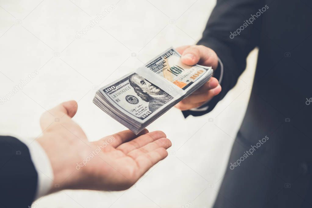 Businessman giving or paying money to a man