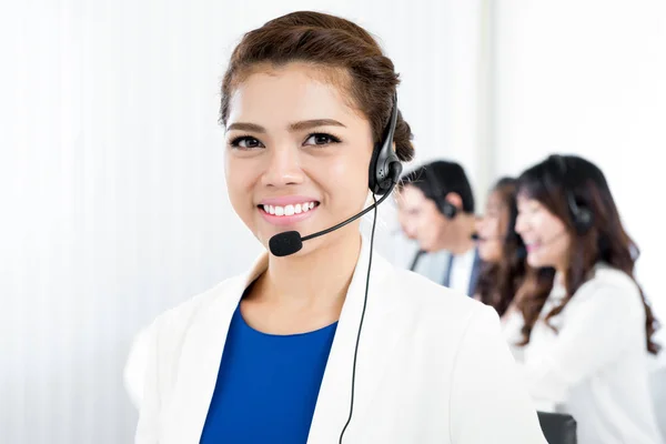 Femme souriante portant un casque microphone comme opérateur — Photo