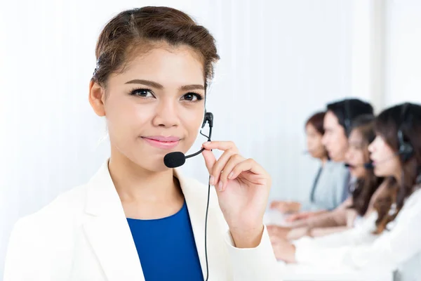 Smiling woman wearing microphone headset as an operator — Stock Photo, Image