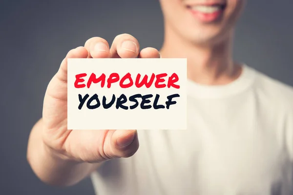 EMPOWER YOURSELF, message on the card shown by a man — Stock Photo, Image