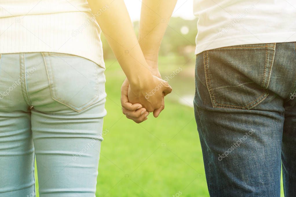 Young couple holding hands in the park