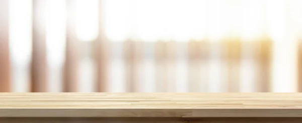 Table top on blur vertical wood slat background with sunlight